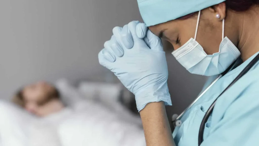 close-up-doctor-praying-patient